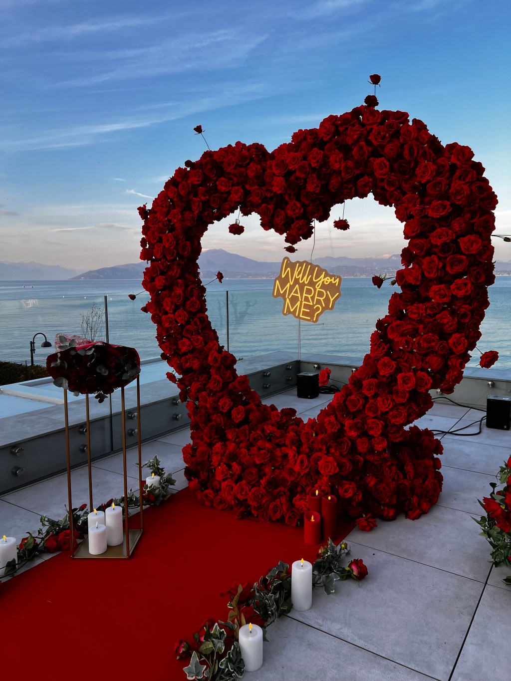 Lake Garda proposal package with romantic heart floral setup at sunset